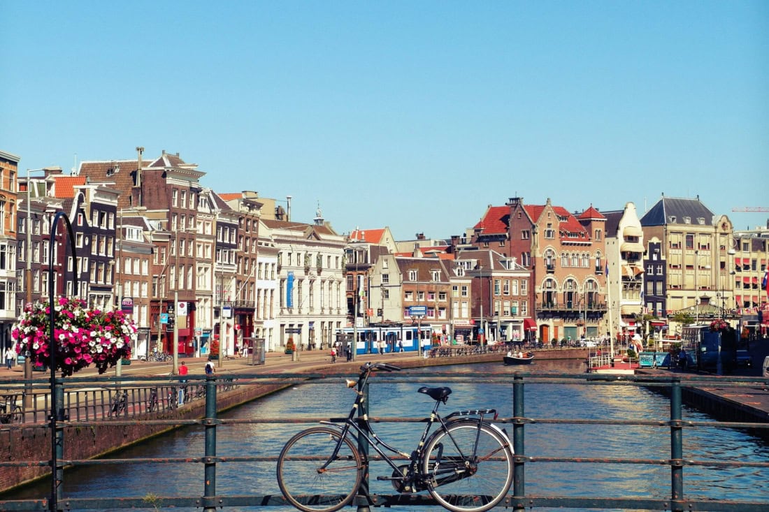 Cyclist and canals with historic buildings in the Netherlands, information for foreigners.
